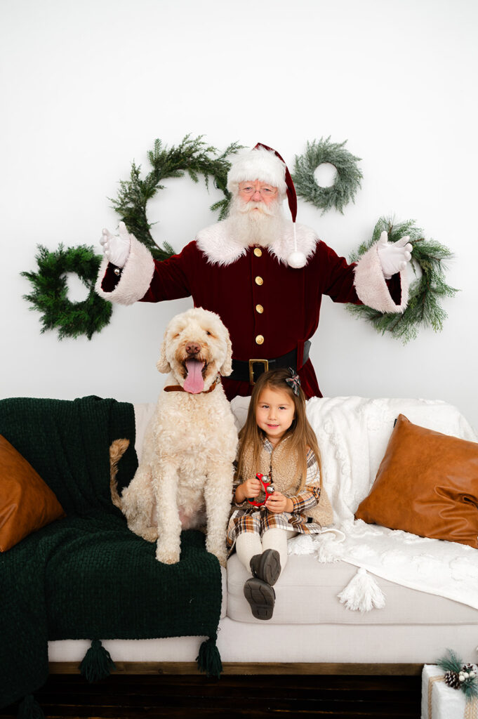 Young girl and her dog photographed with Santa