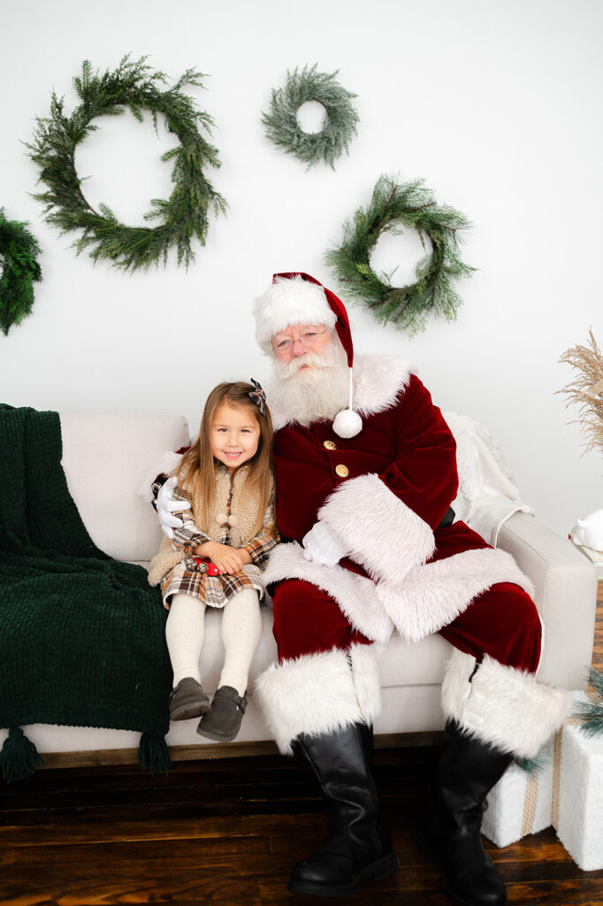 Young girl photographed with Santa from Santa Photo Sessions in Hartford, CT