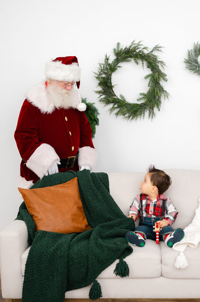 Young boy photographed with Santa from Santa Photo Sessions in Hartford, CT